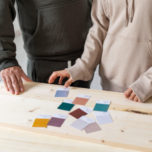 A couple looking at clour swatches to paint thie house.