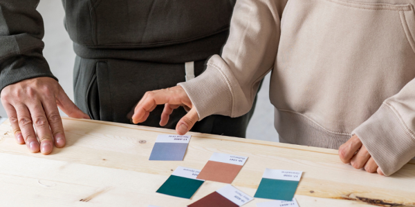 A couple looking at clour swatches to paint thie house.